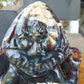 974 gr 9x6x2.8 in The carving of *Lord Ganesha* (God of Knowledge and Remover of Obstacles) on *Indonesian Dark Green Amber*