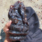 974 gr 9x6x2.8 in The carving of *Lord Ganesha* (God of Knowledge and Remover of Obstacles) on *Indonesian Dark Green Amber*